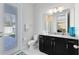 Bright bathroom with a modern toilet, sleek door to the outside and granite countertop at 8390 Ludington Cir, Orlando, FL 32836
