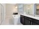 Bathroom features a built-in tub, glass-enclosed shower, and a granite countertop at 8390 Ludington Cir, Orlando, FL 32836