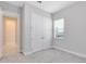 Neutral bedroom with double door closet and window with coverings at 8390 Ludington Cir, Orlando, FL 32836