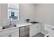 Bright kitchen space with stainless steel appliances, white cabinetry, and modern fixtures at 8390 Ludington Cir, Orlando, FL 32836