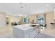 Open-concept kitchen with stainless steel appliances, a large island, and modern fixtures at 8390 Ludington Cir, Orlando, FL 32836