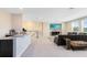 Open-concept living area with a bar, tv and comfortable seating perfect for entertaining or relaxing at 8390 Ludington Cir, Orlando, FL 32836