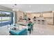 Open-concept living room featuring a large island, modern finishes, and a sliding glass door at 8390 Ludington Cir, Orlando, FL 32836