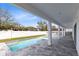 A refreshing pool highlights the backyard of this home with a covered patio for shade at 8390 Ludington Cir, Orlando, FL 32836
