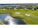 Aerial view of a golf course featuring lush green fairways and pristine water features at 8824 Cruden Bay Ct, Davenport, FL 33896