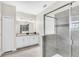 Bright bathroom featuring modern fixtures, tiled walk-in shower, and a double sink vanity at 8824 Cruden Bay Ct, Davenport, FL 33896