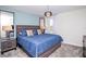 Bedroom featuring a blue accent wall, queen bed, nightstand, and decorative lighting at 8824 Cruden Bay Ct, Davenport, FL 33896