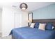 Bedroom featuring a blue accent wall, queen bed, and decorative lighting at 8824 Cruden Bay Ct, Davenport, FL 33896