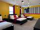 Fun bright bedroom featuring three beds, black furniture, and stylish light fixture at 8824 Cruden Bay Ct, Davenport, FL 33896