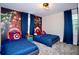 Marvel themed bedroom featuring two beds with character-themed wallpaper and decor at 8824 Cruden Bay Ct, Davenport, FL 33896