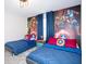 Marvel themed bedroom featuring two beds with character-themed wallpaper and decor at 8824 Cruden Bay Ct, Davenport, FL 33896