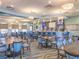 Spacious clubhouse dining area with tables, chairs, and a bar, perfect for gatherings at 8824 Cruden Bay Ct, Davenport, FL 33896
