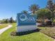 Oasis Clubhouse sign at ChampionsGate; lush landscaping, perfect for luxury living at 8824 Cruden Bay Ct, Davenport, FL 33896