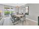 Bright dining room with sleek table, chairs, and access to an outdoor pool area at 8824 Cruden Bay Ct, Davenport, FL 33896