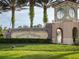 ChampionsGate entrance with beautiful landscaping, brick signage, and decorative architecture at 8824 Cruden Bay Ct, Davenport, FL 33896