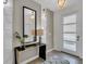 Bright entryway featuring a console table with lamps, a decorative mirror, patterned rug, and a view of the front door at 8824 Cruden Bay Ct, Davenport, FL 33896