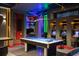 Game room with pool table, vintage arcade games, and colorful lighting at 8824 Cruden Bay Ct, Davenport, FL 33896