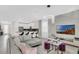Spacious living room with a gray sofa, modern lighting, and an open layout to the kitchen at 8824 Cruden Bay Ct, Davenport, FL 33896