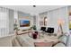 Living area with TV, modern furniture, light gray paint, and access to outdoor pool at 8824 Cruden Bay Ct, Davenport, FL 33896