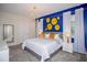 Luxurious main bedroom with a king-size bed, blue accent wall, and modern lighting at 8824 Cruden Bay Ct, Davenport, FL 33896
