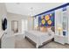 Modern main bedroom features a king bed, blue accent wall with golden decor, and soft carpeting at 8824 Cruden Bay Ct, Davenport, FL 33896