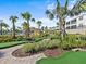 Beautifully landscaped mini golf area surrounded by lush tropical foliage, and community buildings at 8824 Cruden Bay Ct, Davenport, FL 33896