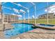 Inviting screened-in pool and hot tub with brick-paver deck and view of manicured lawn and blue skies at 8824 Cruden Bay Ct, Davenport, FL 33896
