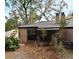 Cozy patio area with a screened-in porch, AC unit, and a lush natural setting at 940 Douglas Ave # 170, Altamonte Springs, FL 32714