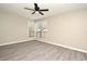 Bright bedroom with a large window, ceiling fan, and modern gray wood-look flooring at 940 Douglas Ave # 170, Altamonte Springs, FL 32714