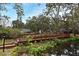 Picturesque community bridge offering charming views of a pond and lush landscaping and amenities in the distance at 940 Douglas Ave # 170, Altamonte Springs, FL 32714
