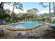 Community pool featuring ample lounge seating, mature trees, and a well-maintained deck and landscaping at 940 Douglas Ave # 170, Altamonte Springs, FL 32714