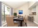 Staged dining area with large window and vaulted ceiling, next to countertop and stools at 940 Douglas Ave # 170, Altamonte Springs, FL 32714