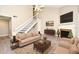 Staged living room with fireplace, with neutral furnishings, creating a warm and inviting space at 940 Douglas Ave # 170, Altamonte Springs, FL 32714