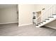 Open-concept living room with new flooring, bright natural light, and staircase to the second level at 940 Douglas Ave # 170, Altamonte Springs, FL 32714