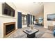 Staged living room with fireplace, TV, and neutral furnishings, creating a warm and inviting space at 940 Douglas Ave # 170, Altamonte Springs, FL 32714