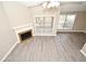 Aerial view of the living room with a corner fireplace, multiple windows, and new flooring at 940 Douglas Ave # 170, Altamonte Springs, FL 32714