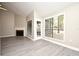 Bright living room with a fireplace, big windows, door to exterior, and wood-look flooring at 940 Douglas Ave # 170, Altamonte Springs, FL 32714