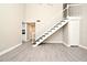 A modern living room features a white staircase and wood look flooring at 940 Douglas Ave # 170, Altamonte Springs, FL 32714