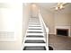 Staircase leading to the upper level with contrasting steps and a view into the living room at 940 Douglas Ave # 170, Altamonte Springs, FL 32714