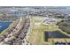 Wide aerial shot of neighborhood featuring community park, baseball field, waterways, and rows of similar homes at 10209 Henbury St, Orlando, FL 32832
