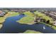 Aerial view of community golf course featuring sand traps, putting greens, fountain, and waterways at 10209 Henbury St, Orlando, FL 32832