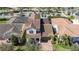 Aerial view of a home with a terracotta roof, palm trees, and colorful landscaping at 10209 Henbury St, Orlando, FL 32832