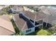 An aerial view of the back of a home with a covered patio and fenced-in yard at 10209 Henbury St, Orlando, FL 32832