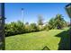 Lush backyard with green lawn, manicured hedges, and privacy fence at 10209 Henbury St, Orlando, FL 32832