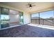 Covered balcony featuring brick flooring, a ceiling fan, and a sliding glass door to the bedroom at 10209 Henbury St, Orlando, FL 32832
