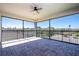 Large covered brick-paved balcony offering views of the community and a ceiling fan at 10209 Henbury St, Orlando, FL 32832