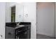 Elegant bathroom featuring a dark vanity with a granite countertop and a decorative faucet at 10209 Henbury St, Orlando, FL 32832