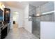 Modern bathroom with large glass shower, tiled walls, and dark cabinets at 10209 Henbury St, Orlando, FL 32832