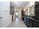 Luxurious bathroom with double vanity, modern fixtures, and glass-enclosed shower, offering spa-like comfort at 10209 Henbury St, Orlando, FL 32832