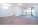 Large bedroom with carpeted floors and sliding glass doors leading to screened outdoor area at 10209 Henbury St, Orlando, FL 32832